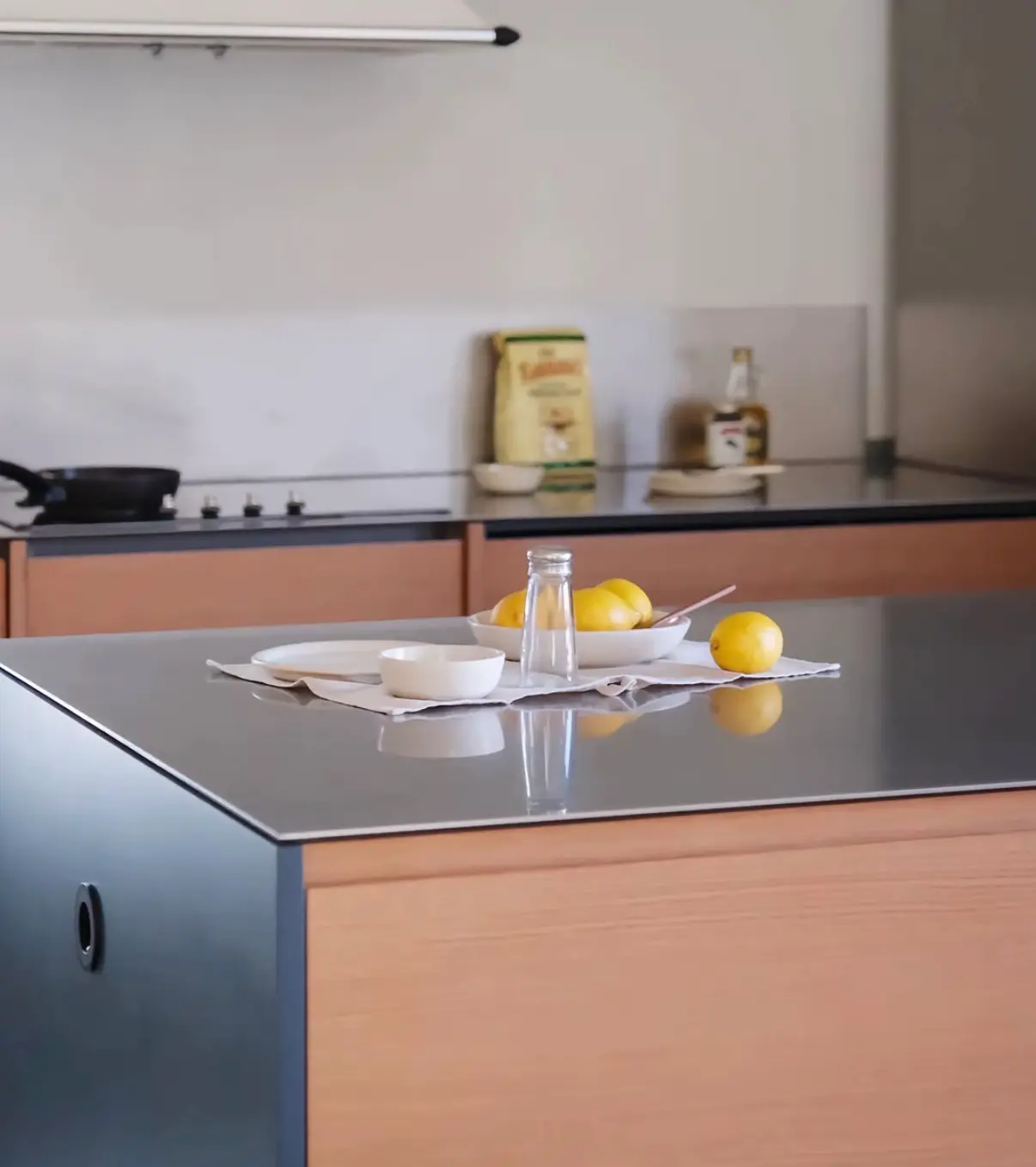 Stainless steel kitchen island countertop with dark cabinet base